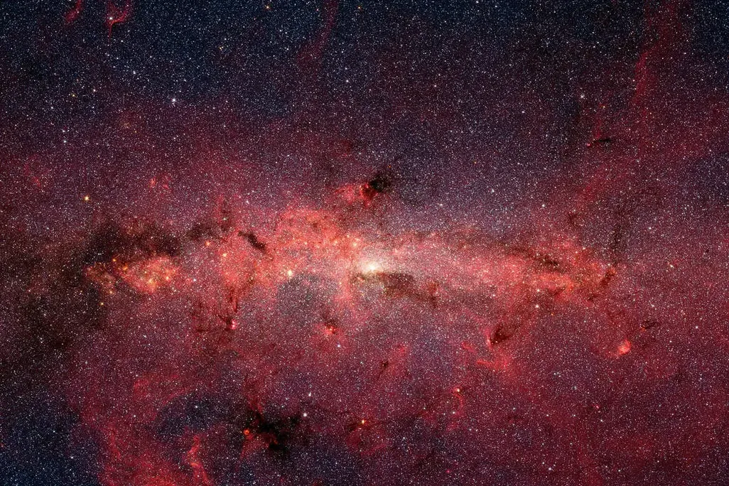 image of the center of galaxy showing stars on a black and red background