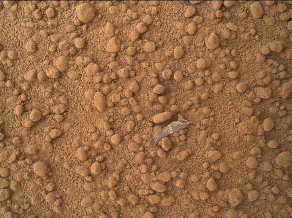 The first shiny object found on Mars, thought to be plastic shed from Curiosity.