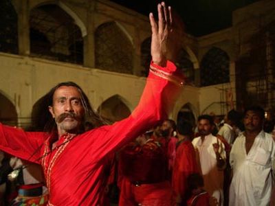 A Sufi pilgrim dances at the shrine of Lal Shahbaz Qalandar, in Sehwan Sharif, Pakistan, in 2006.