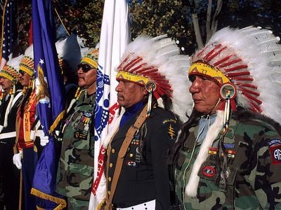 Native American veterans of the Vietnam War stand in honor as part of the color guard at the Vietnam Veterans War Memorial. November 11, 1990, Washington, D.C.  (Photo by Mark Reinstein/Corbis via Getty Images)