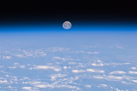 The full moon is seen near Earth's horizon from the International Space Station.
