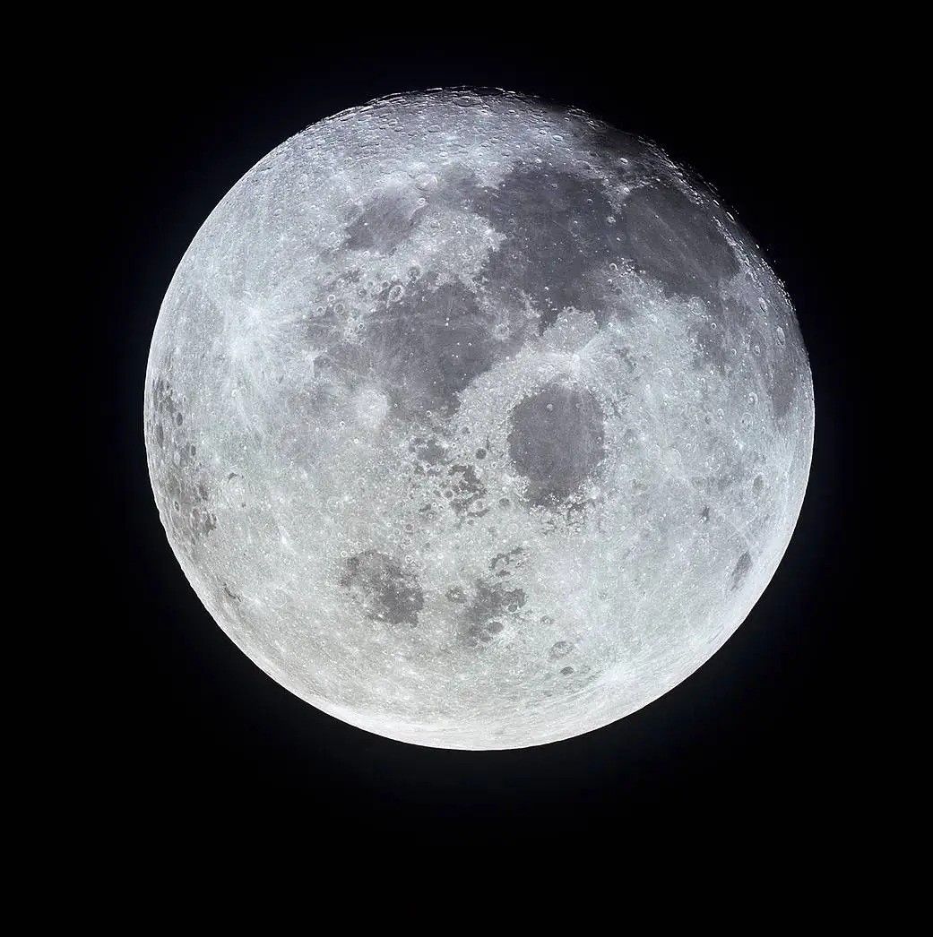the full moon against a black backdrop of space