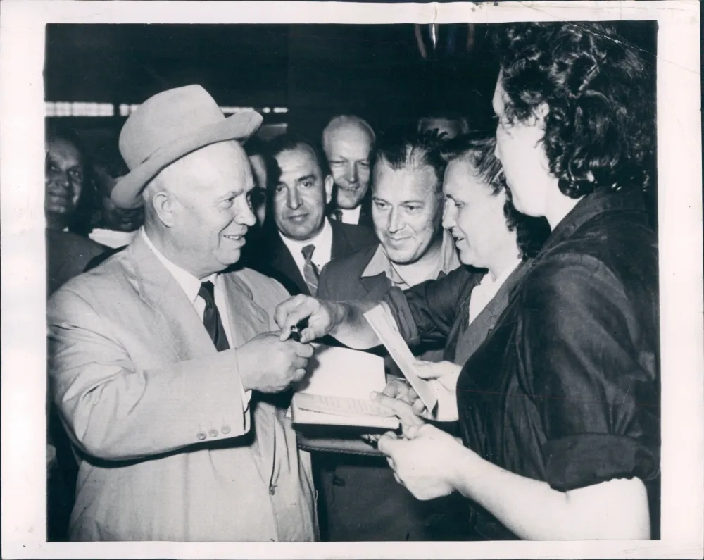 Khrushchev signs autographs for his “fans”–workers at an Eastern bloc factory.