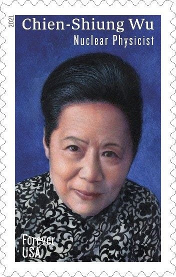 A postage stamp picturing a close up of nuclear physicist Chien-Shiung Wu. She has dark hair is wearing a black and white patterned dress.  Chien-Shiung is pictured against a dark blue background 