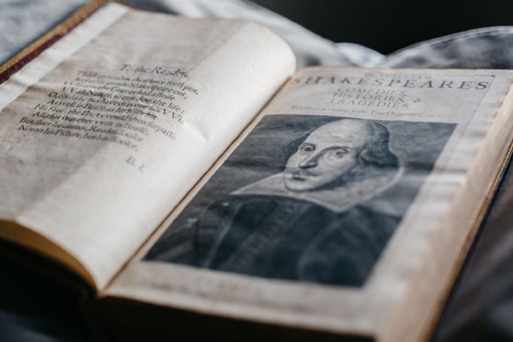 Open book with illustration of Shakespeare on the right-hand page
