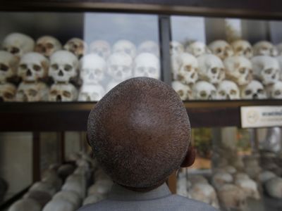 A man looks at skulls and bones of more than 8,000 victims of the Khmer Rouge regime at Choeung Ek, a "Killing Fields" site located on the outskirts of Phnom Penh April 17, 2014.