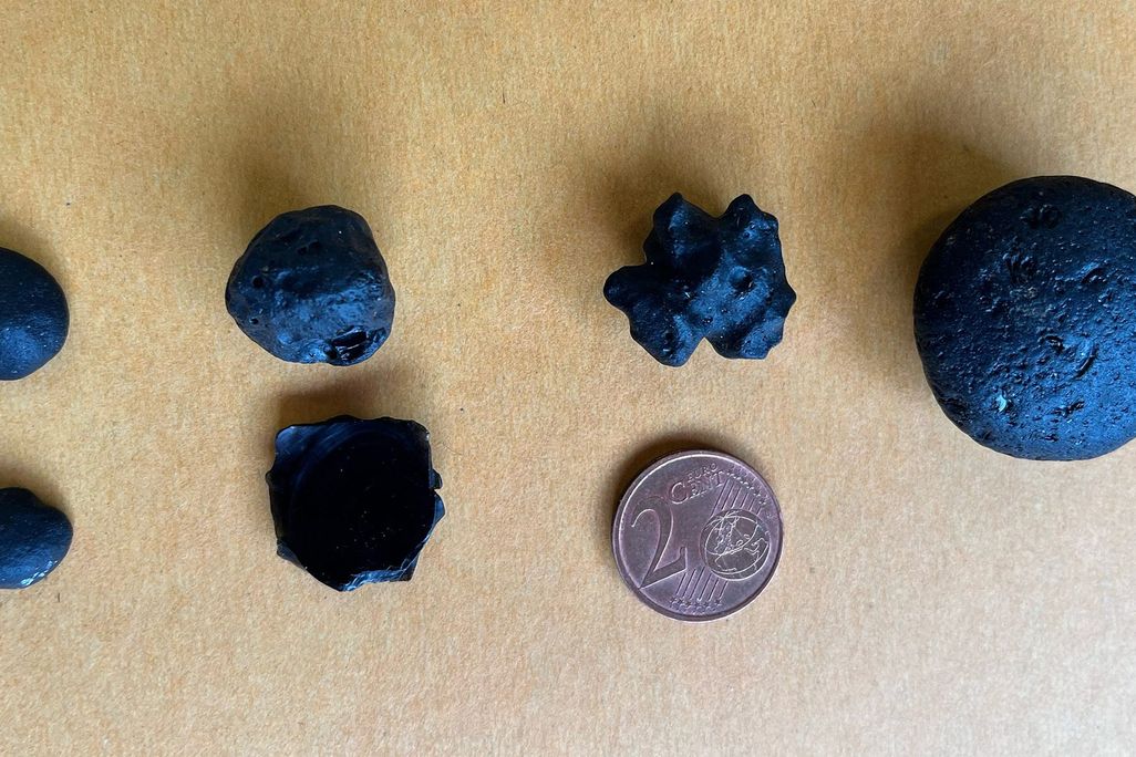 The newly identified tektites next to a two-cent euro coin