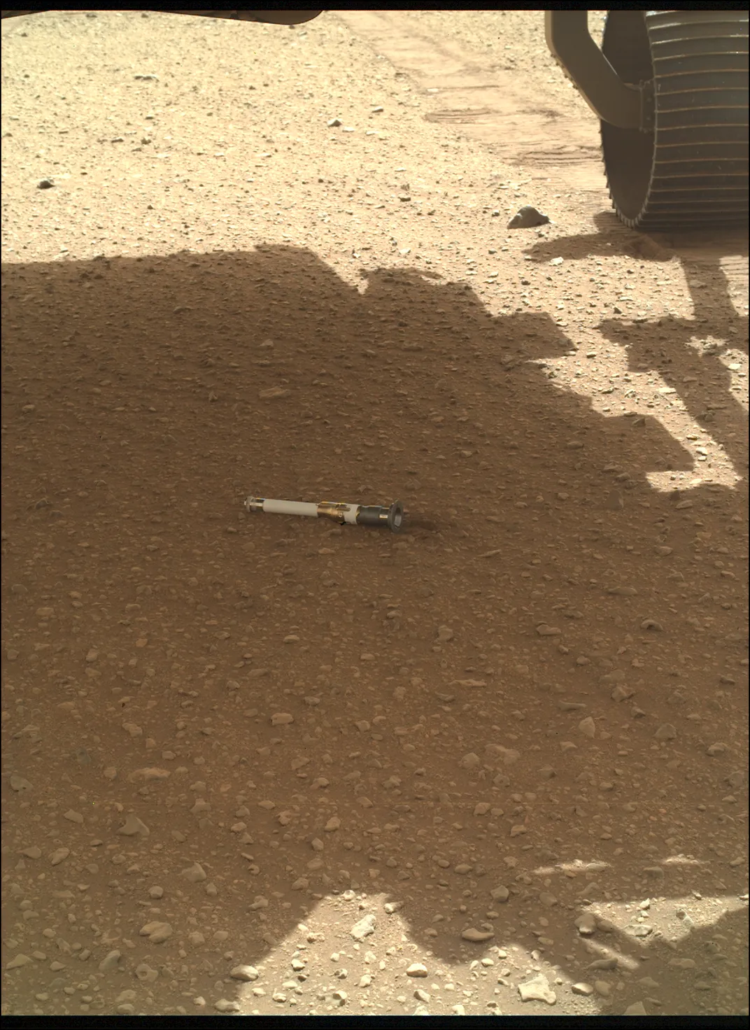 Shadowy image of a tube on the ground