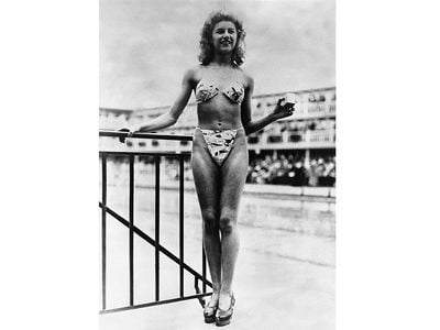 Nude dancer Micheline Bernardini models the first bikini in Paris, France.