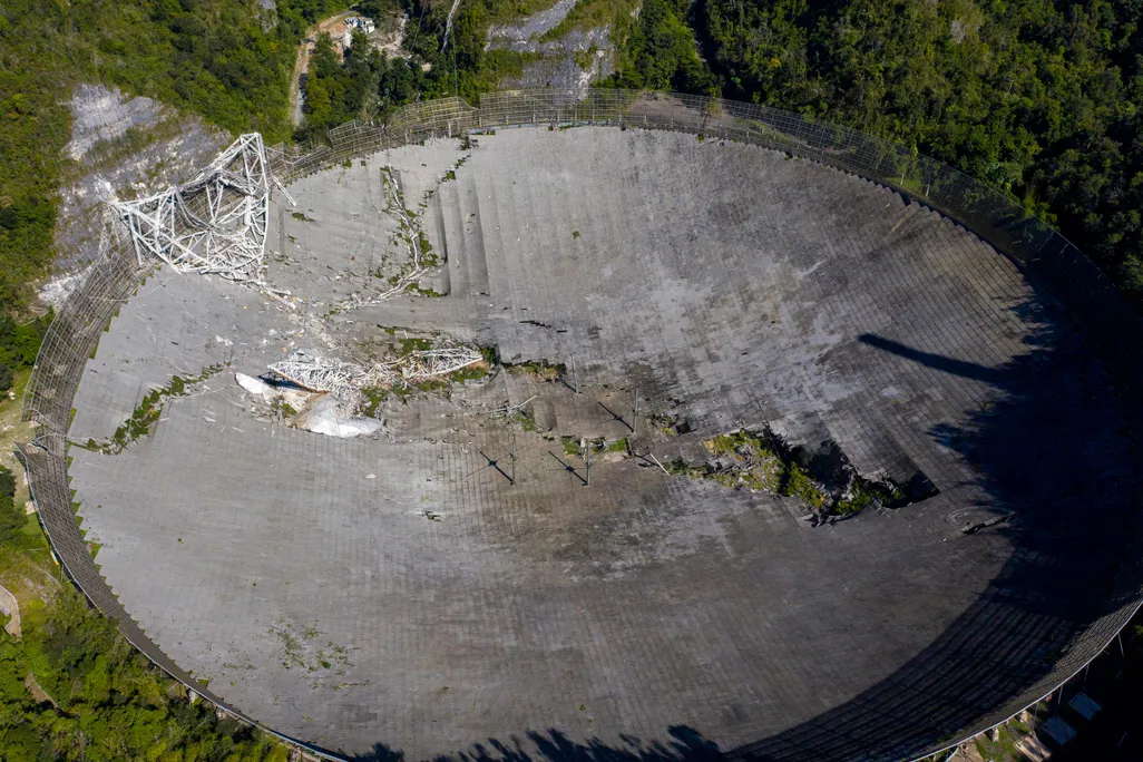This aerial view shows the damage at the Arecibo Observatory after one of the main cables holding the receiver broke in Arecibo, Puerto Rico, on December 1, 2020.