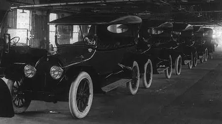 A row of brand new Cadillacs awaits drivers. 1917