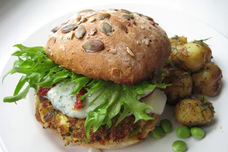 A veggie burger with a zucchini, feta, and pea patty. 