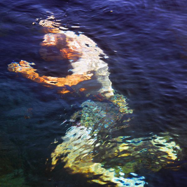 Man under the water of a warm spring thumbnail