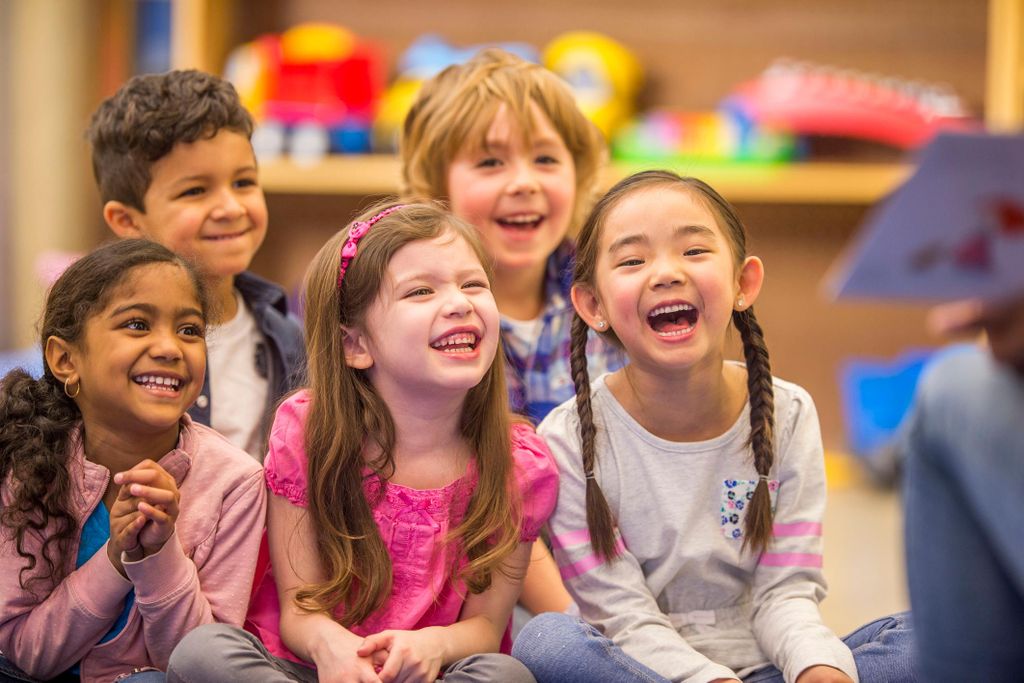 Laughing at teacher with book