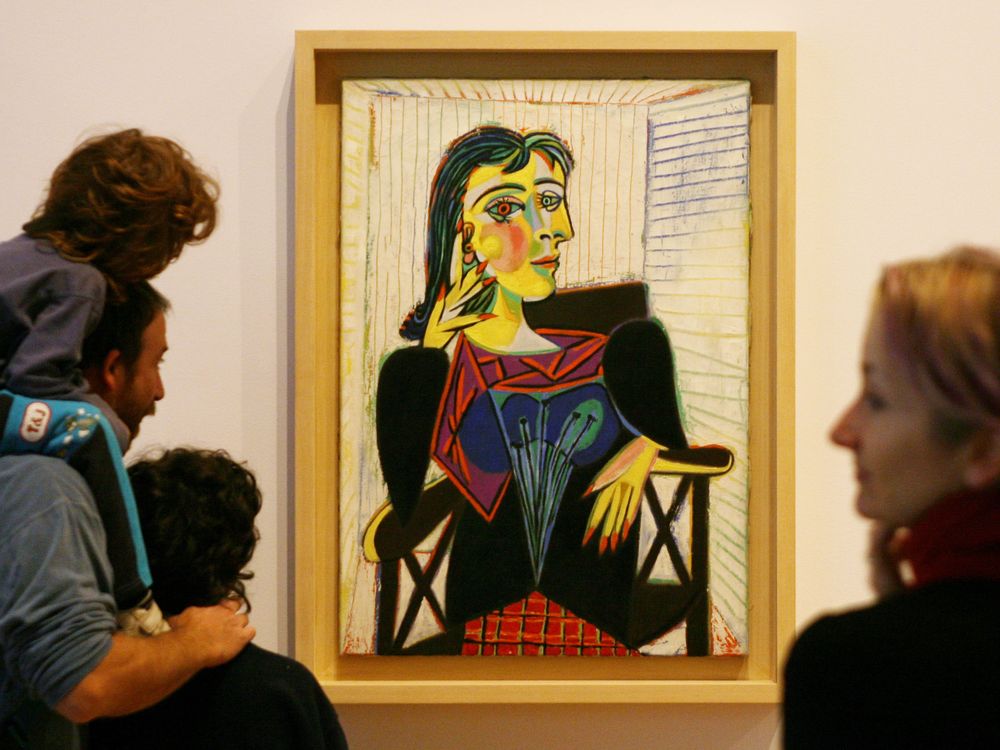 Museum visitors admire a Pablo Picasso portrait of Dora Maar.