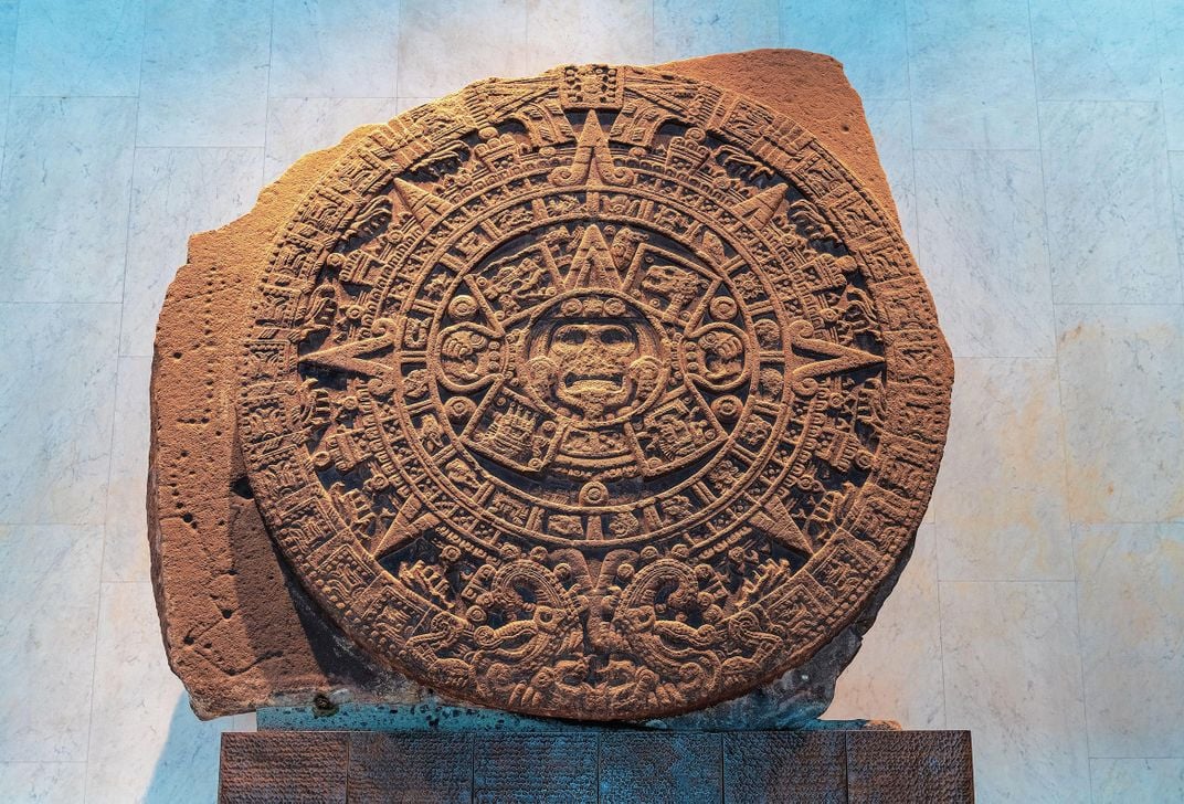 a large stone with carvings on display