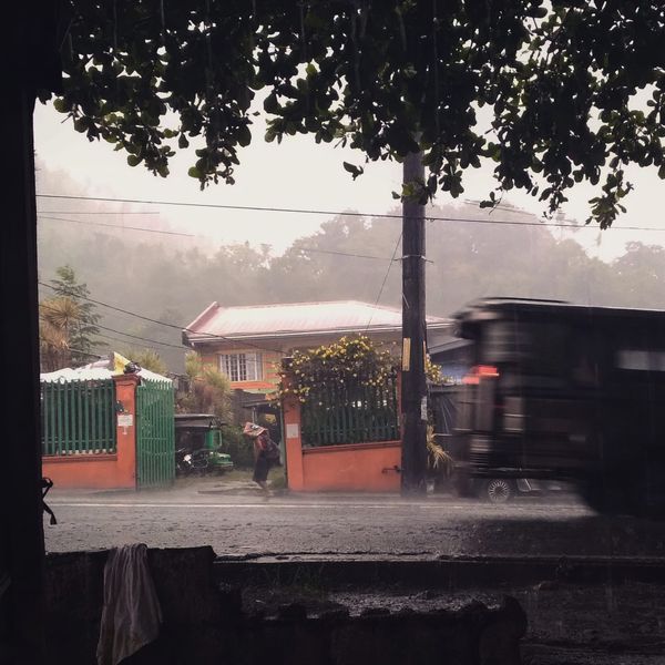 An old man covering his head with a sack under rainfall. thumbnail
