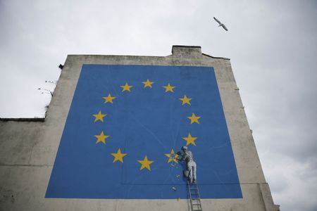 The Banksy mural in Dover, England, showed a worker chipping away a star on the European Union flag.