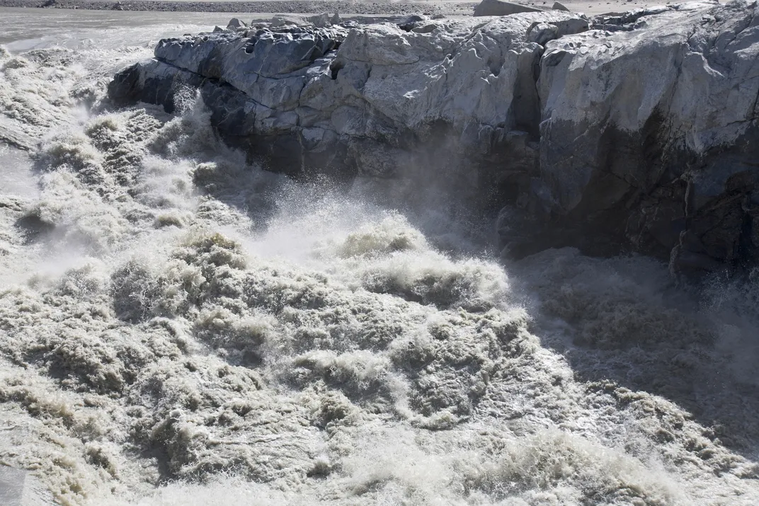 Meltwater surging by a glacier in Greenland