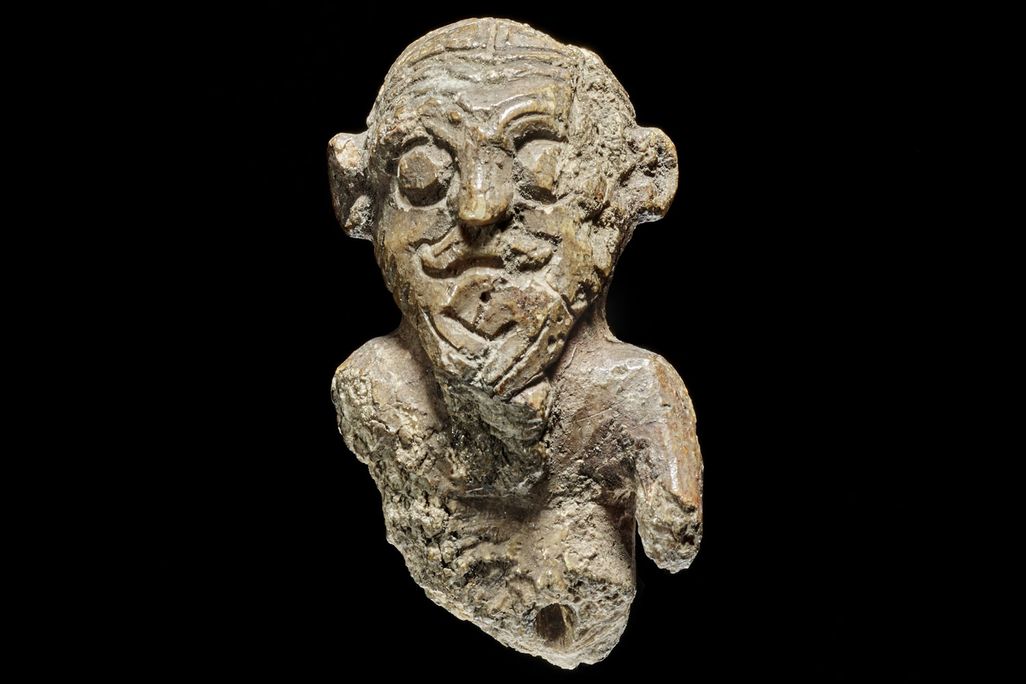Small figurine of a man against a black background
