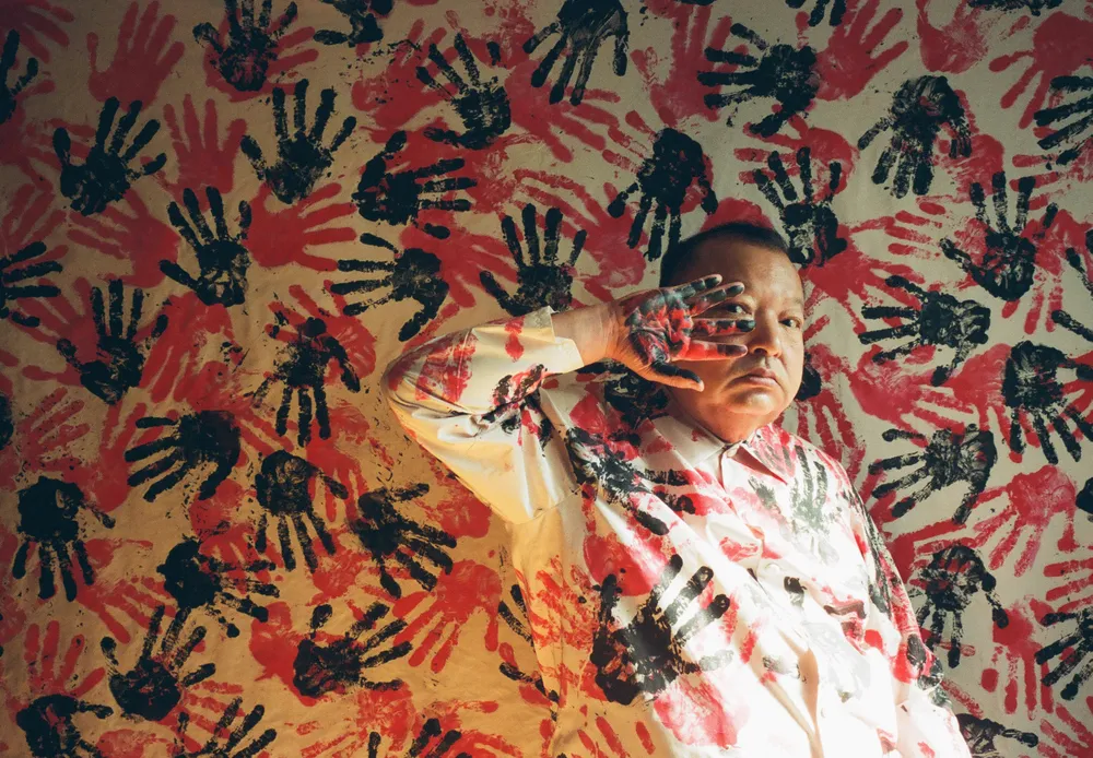 This work is a strange and beautiful portrait of a man standing in front of a background with a handprint pattern such like a cave painting.

Man's dirty hands and face emphasize the strangeness.

The author approached ancient art in search of images that no one else had created.

The pattern was dyed by the author because he is a photographer and fashion designer.

"ARTIST" is both the title and the author himself.