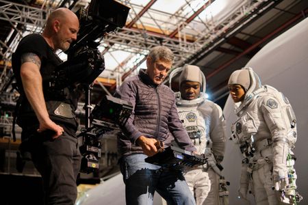 Director-star George Clooney confers with David Oyelowo and Tiffany Boone during the filming of a spacewalk sequence at London's Shepperton Studios.