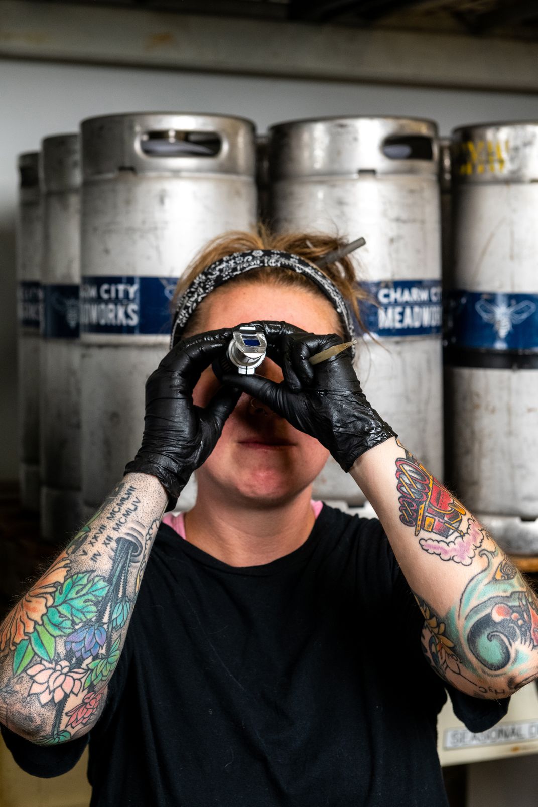 Pronobis looks through a refractometer to measure the sugar content in the must, a mixture of water and honey—two of the basic ingredients of all types of mead.