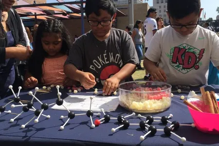 Children participate in a hands-on science activity with the Smithsonian Latino Center for a Dia del Niño festival hosted by LA Plaza de Cultura y Arte in Los Angeles, California.