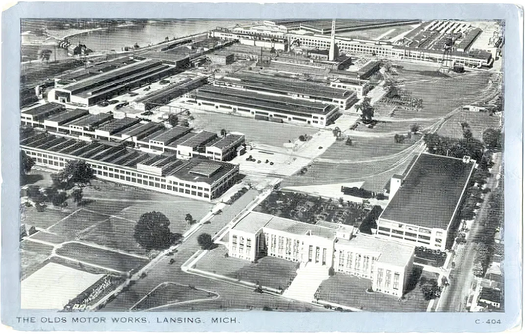 a postcard showing an aerial view of an automobile factory