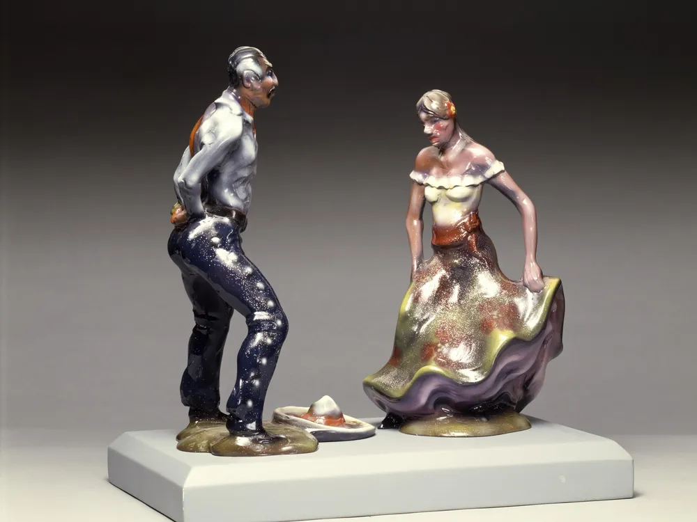 Fiberglass sculpture of a man and a woman at a fiesta.