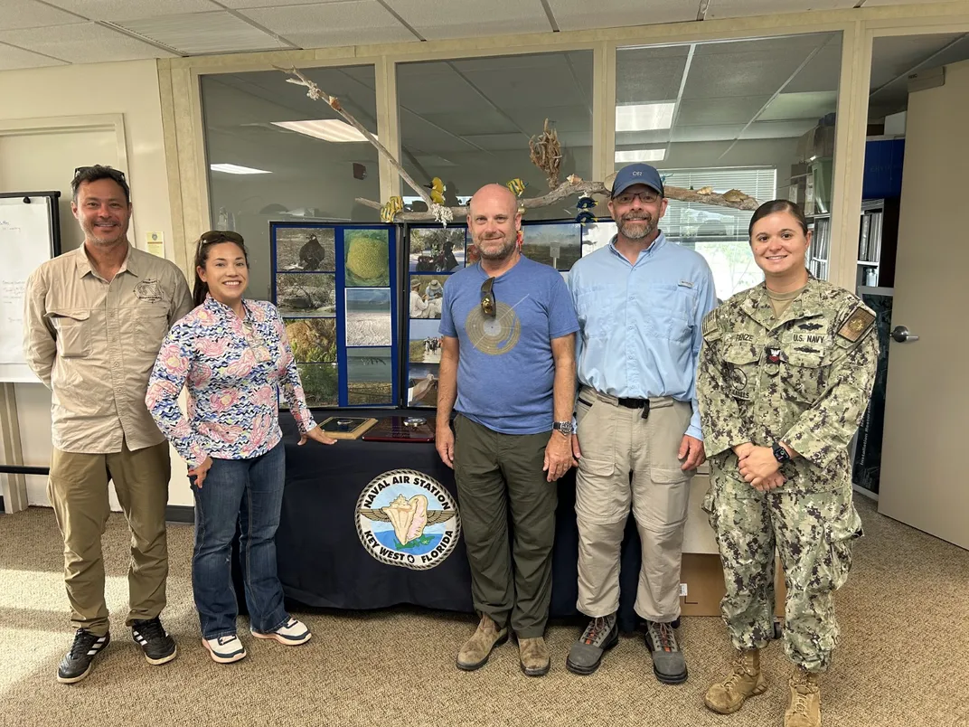 Scientists and military personnel pose together