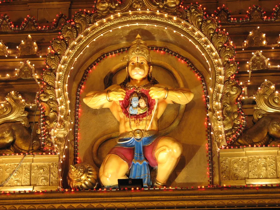 A statue of Hanuman splitting his chest open to reveal an image of Rama and Sita