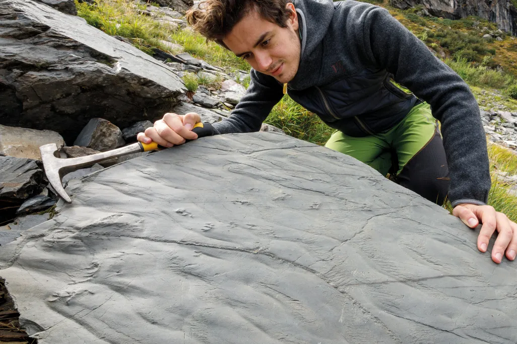 A man pointing to the first boulder discovered