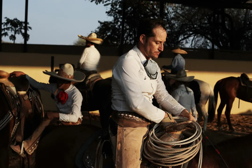 four people sit on their horses