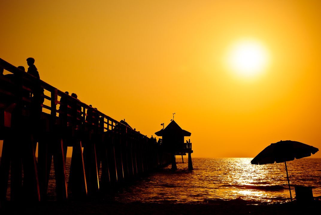 Relaxing in front of the springtime sunset on the beach in Naples ...
