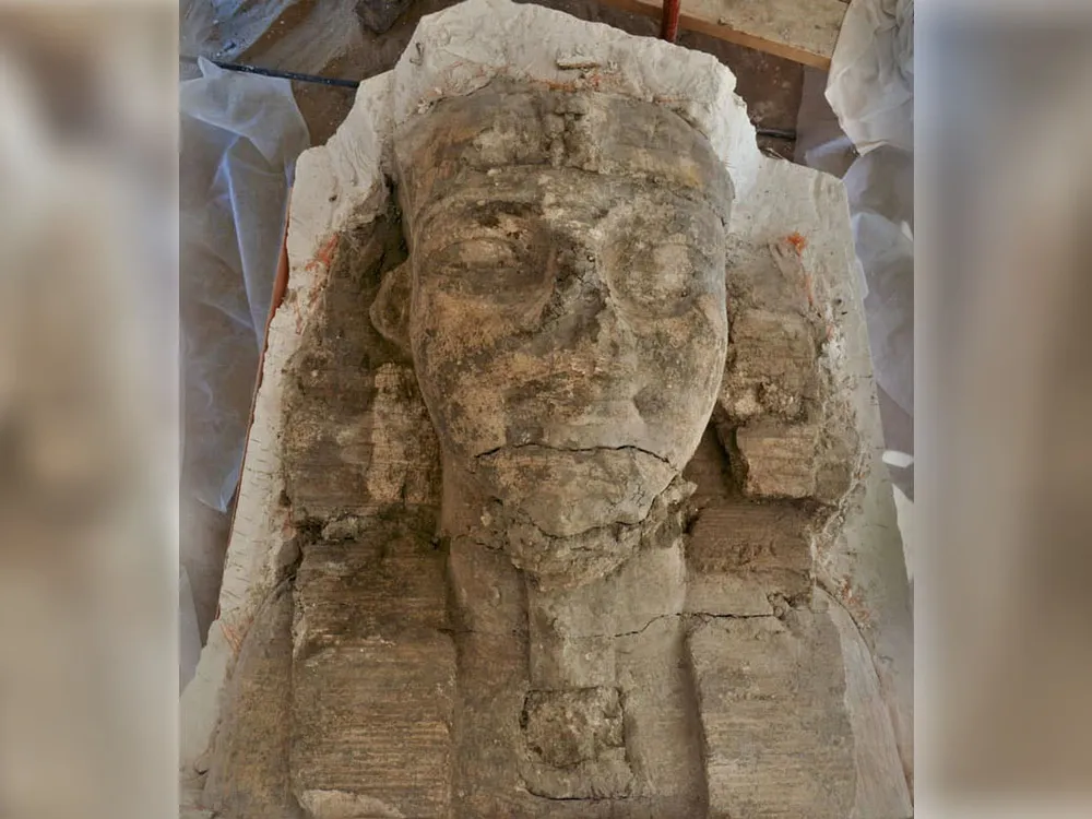 large stone head of man with egyptian headress