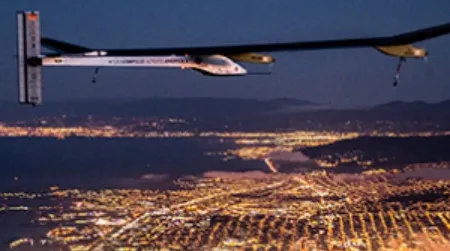 The Solar Impulse flying over San Francisco at night.