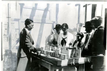 Alice Constance Austin showing model of house to Llano del Rio colonists, May 1, 1917. 