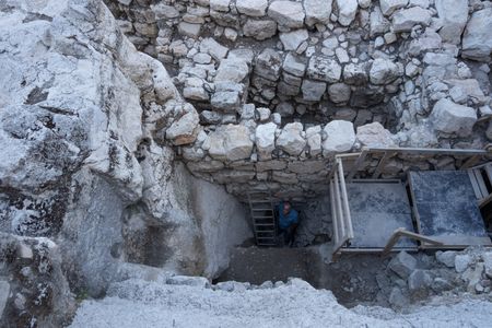 Yuval Gadot stands at the bottom of the recently discovered moat.