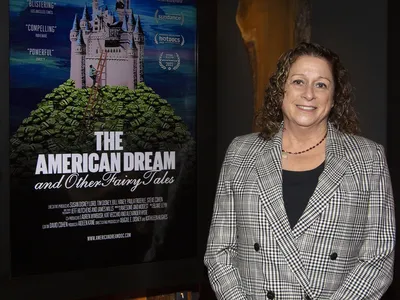 Abigail Disney beside a poster for&nbsp;The American Dream and Other Fairy Tales&nbsp;earlier this month