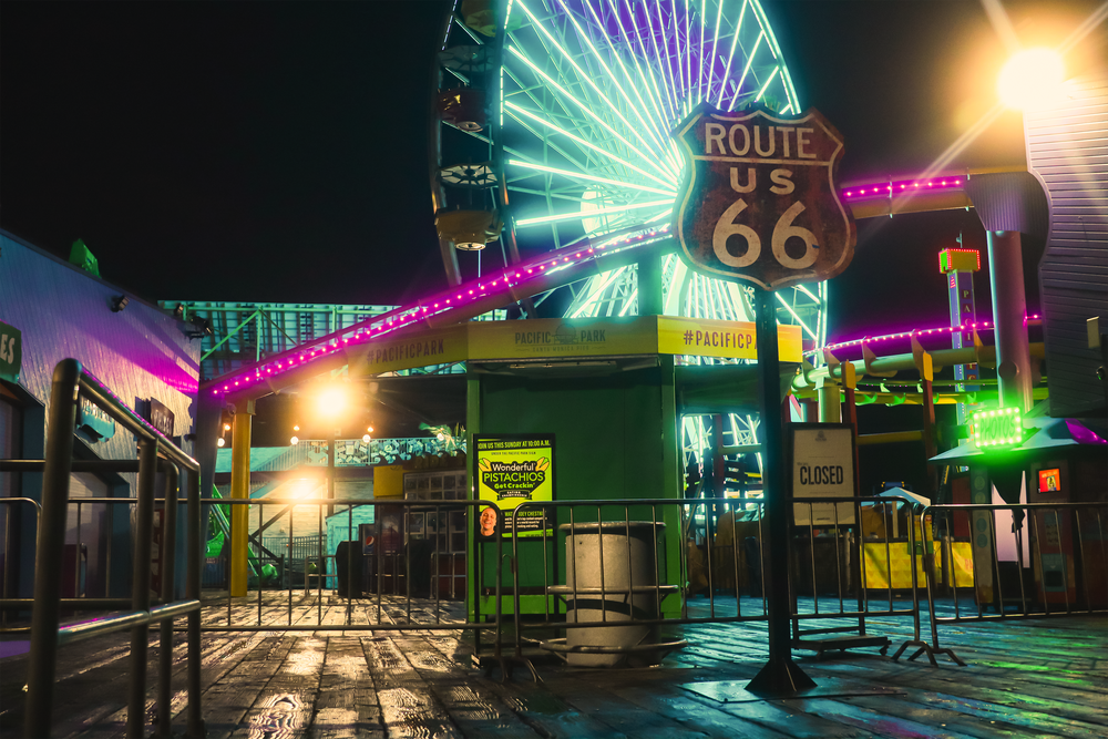 A neon ferris wheel at night