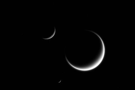 The Cassini spacecraft took this image of three of Saturn's moons, Rhea, Mimas and Titan. 