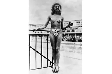 Nude dancer Micheline Bernardini models the first bikini in Paris, France.