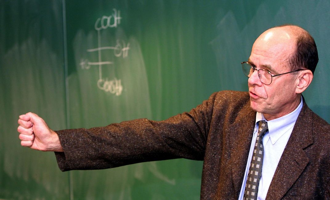 K. Barry Sharpless in front of a chalkboard addressing a reporters and colleagues at Scripps Research Institute in 2001.