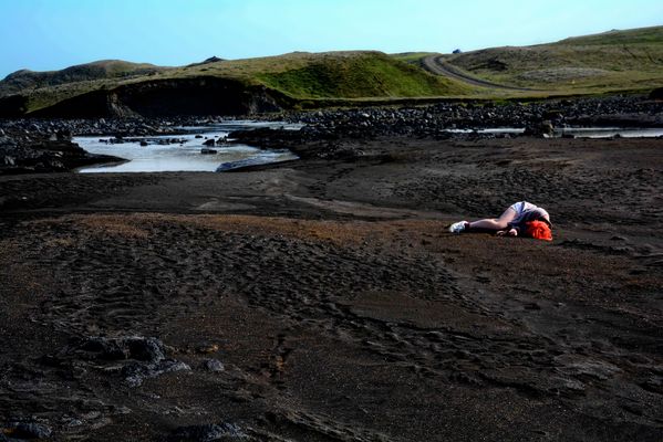My daughter enjoying the warmth of the black sand in Iceland thumbnail
