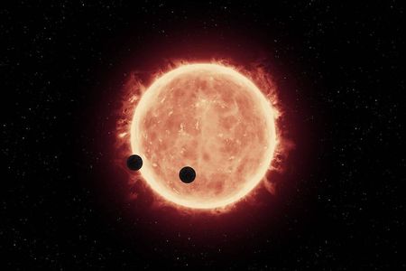 Artist's illustration of the planets, TRAPPIST-1b and TRAPPIST-1c, passing in front of their parent star, which is much smaller and cooler than our sun. 