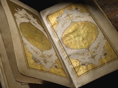 The manuscript features an array of gilded designs and illustrations.