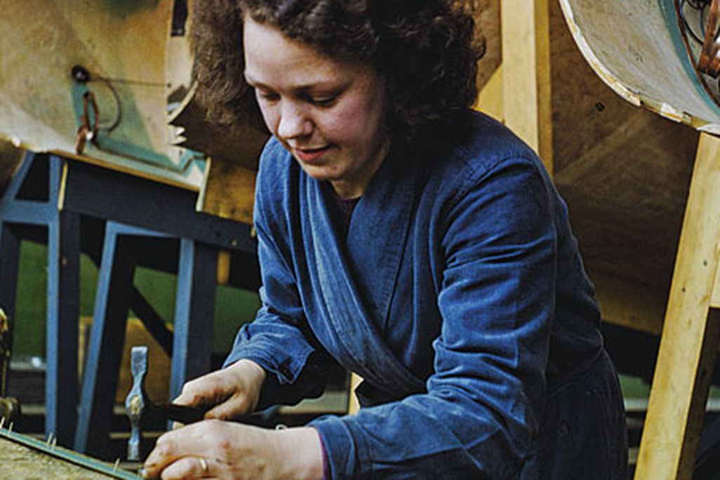 a worker prepares wood strips for a Mosquito hull