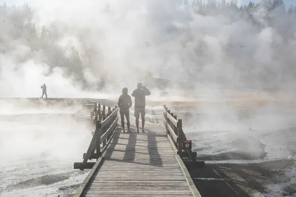 A view of people looking at the Norris Geyser Basin in Yellowstone Park, Wyoming. thumbnail