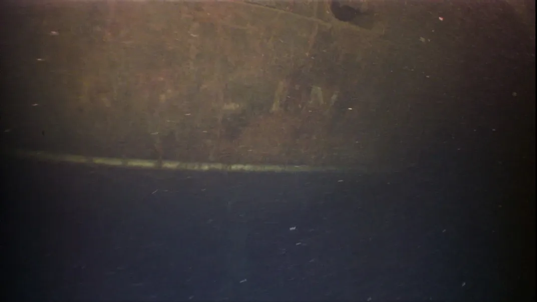 Faded lettering on ship's hull